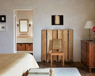 neutral bedroom with vintage wooden screen