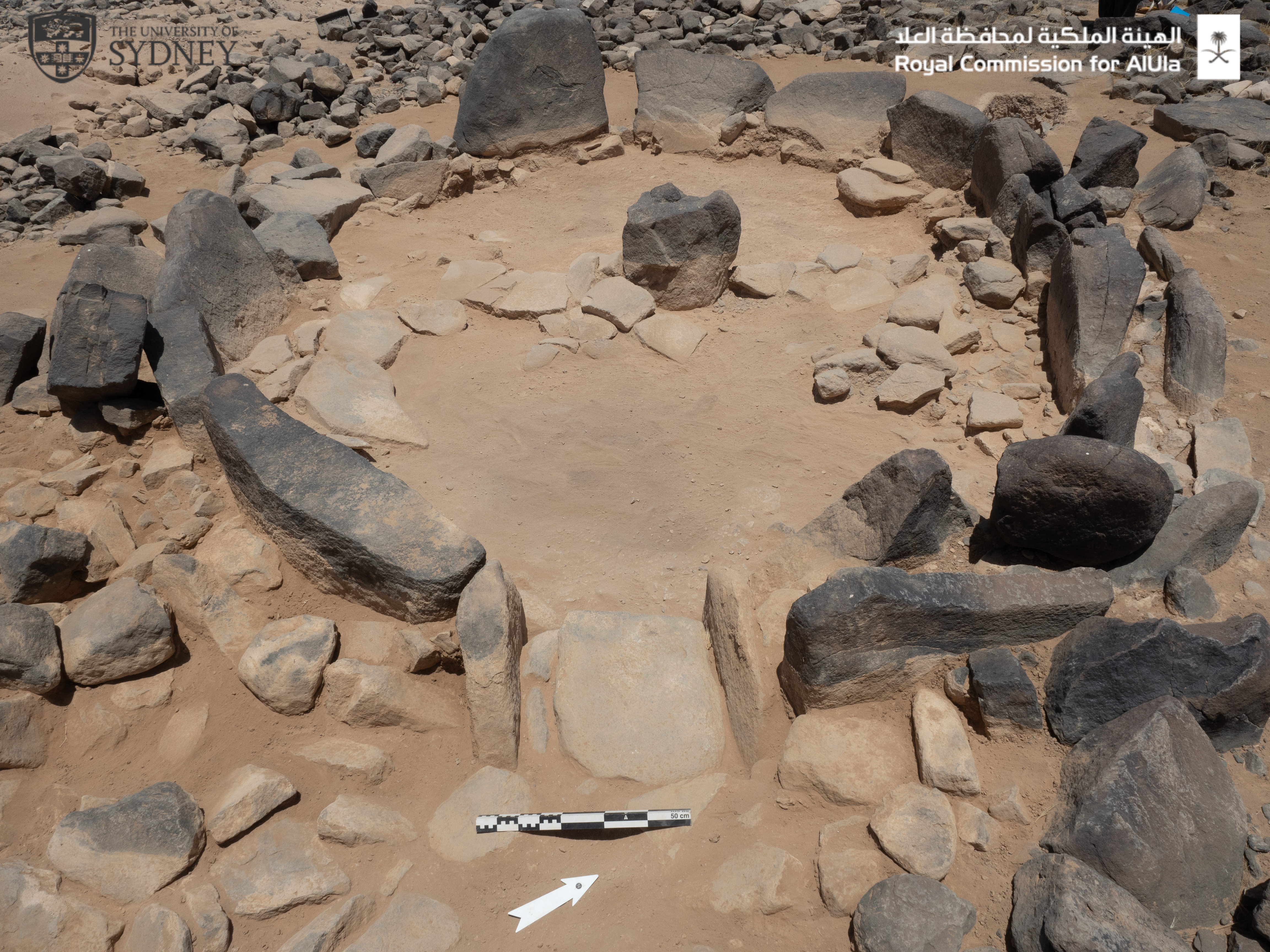 A circle of stones on a dusty landscape