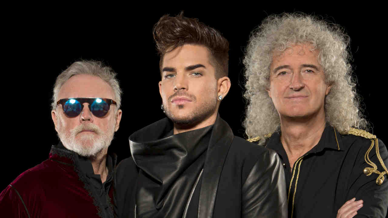 Queen and Adam Lambert posing for a photograph in 2014