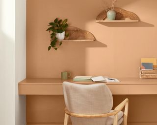 valspar Desert Carnation used to style a boho desk area with floating shelves and a white chair