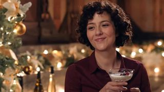 Katie Findlay as Alice drinking an eggnog martini in The 5-Year Christmas Party on Hallmark.