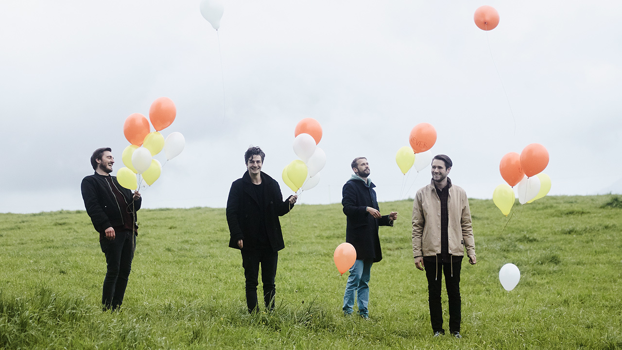 A press shot of Cold Reading looking happy with balloons