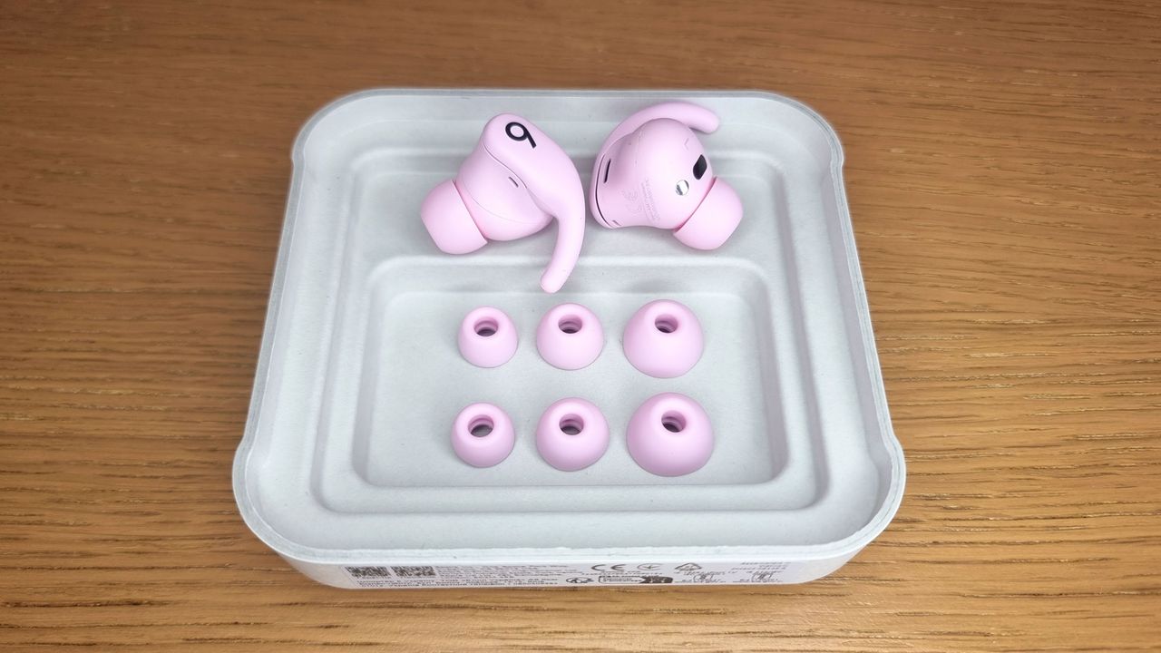 A picture of the Beats Powerbeats Fit earbuds with spare eartips