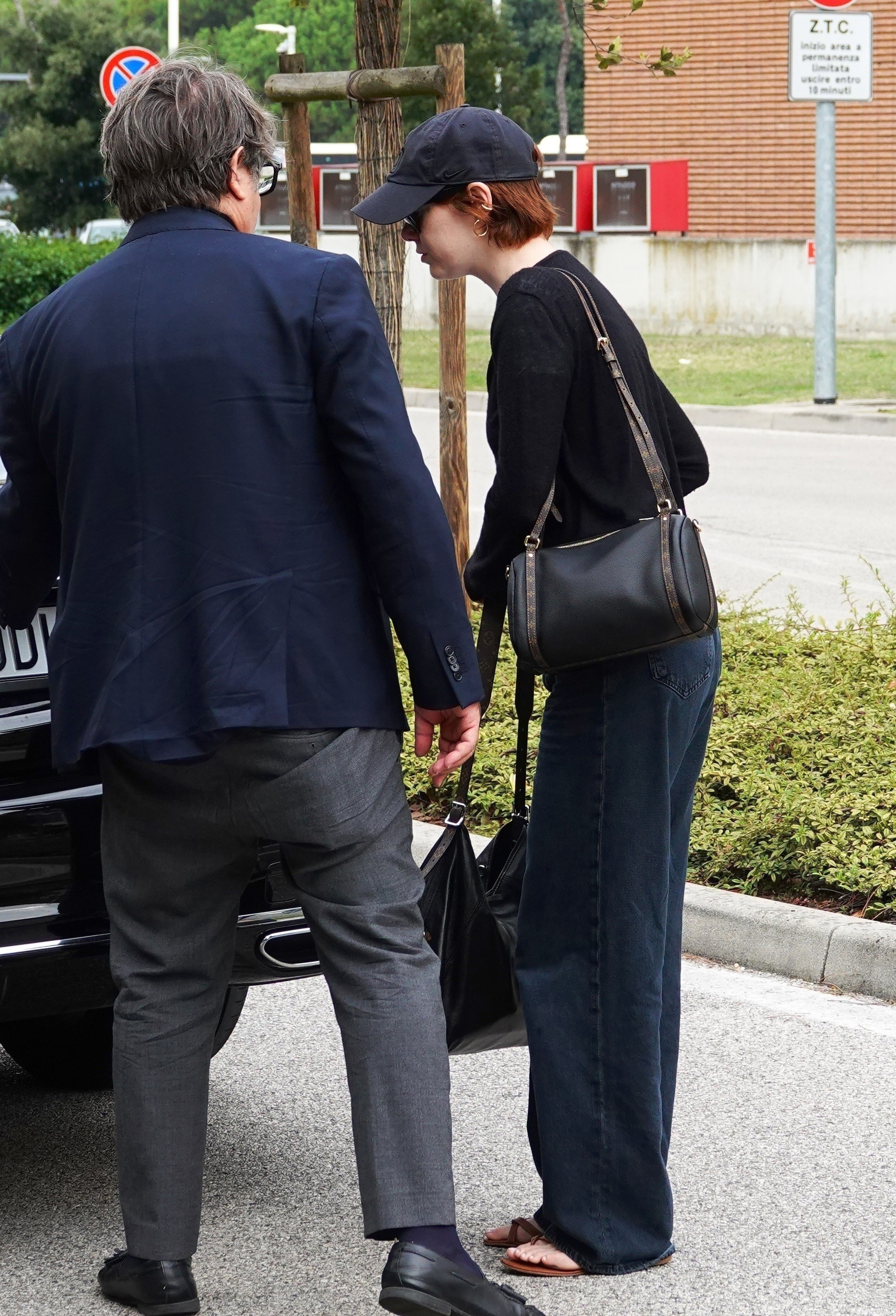 Emma Stone arrived at the Venice Film Festival in the toe-ring sandal trend and two Louis Vuitton bags