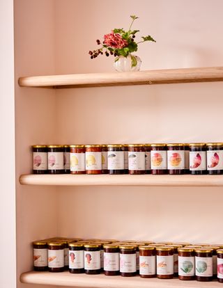 Wooden shelves with jars of preserves at Spring-To-Go in Notting Hill, London