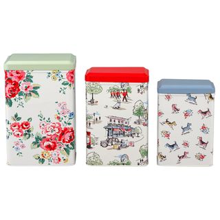 3 Elegant storage tins next to each other with beautiful pictures on them