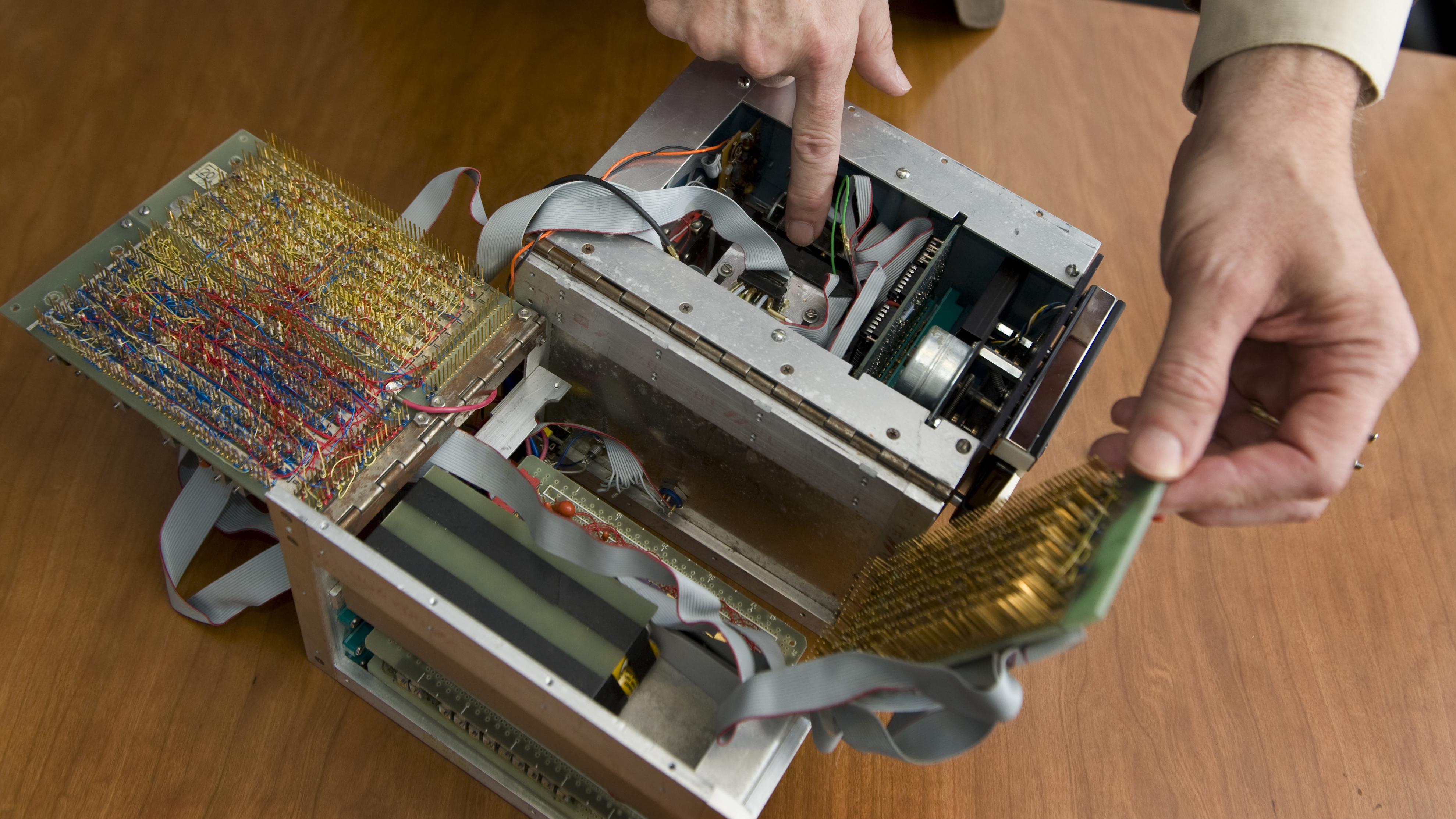 Steve Sasson points to the inner workings of the first handheld digital camera created in 1975