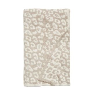 A white and beige leopard print throw blanket