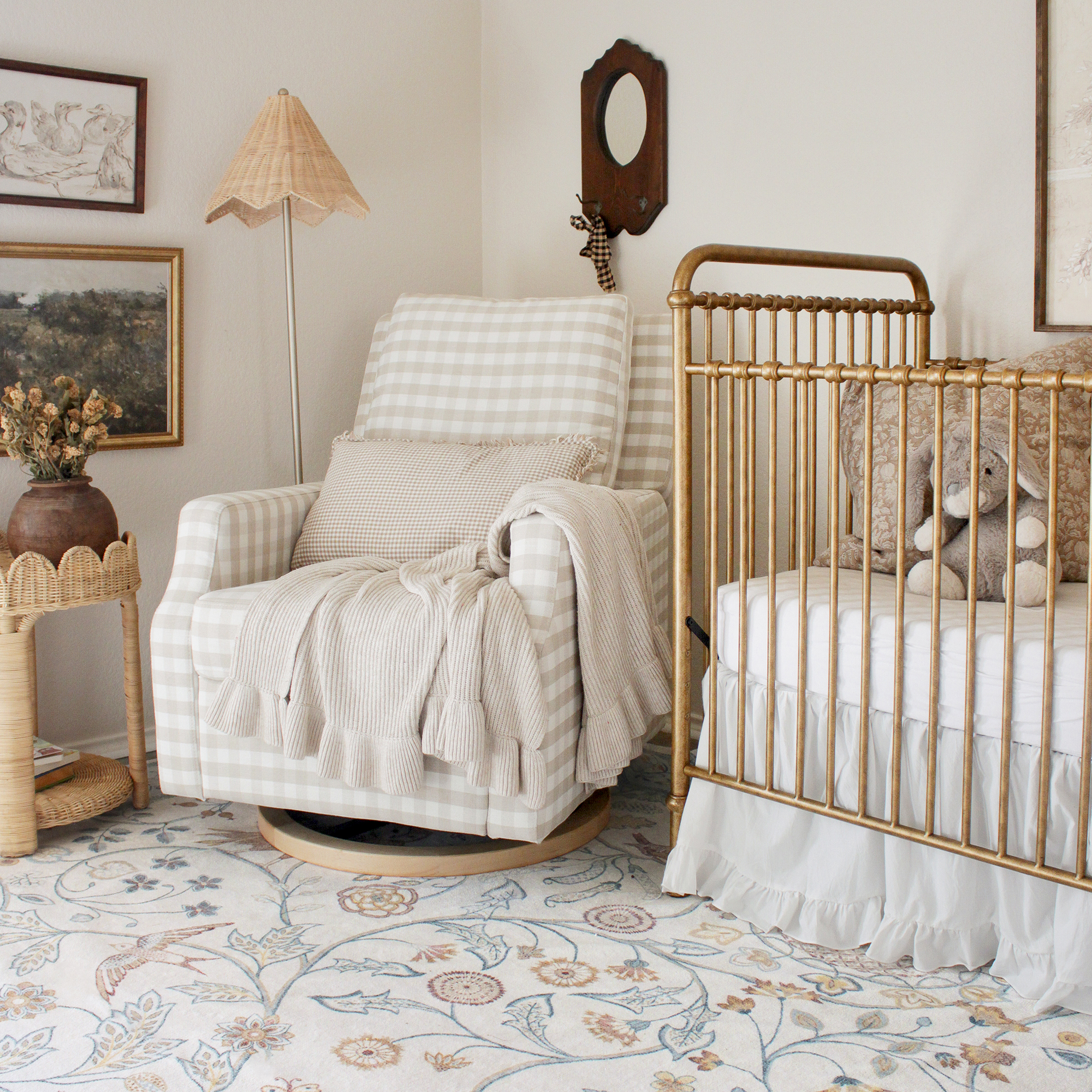 Nursery with pastel rug under cot and nursing chair