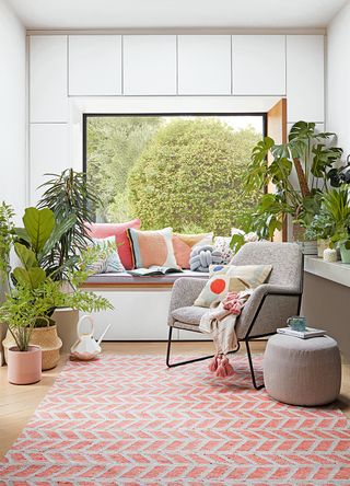 window with a window seat surrounded by houseplants