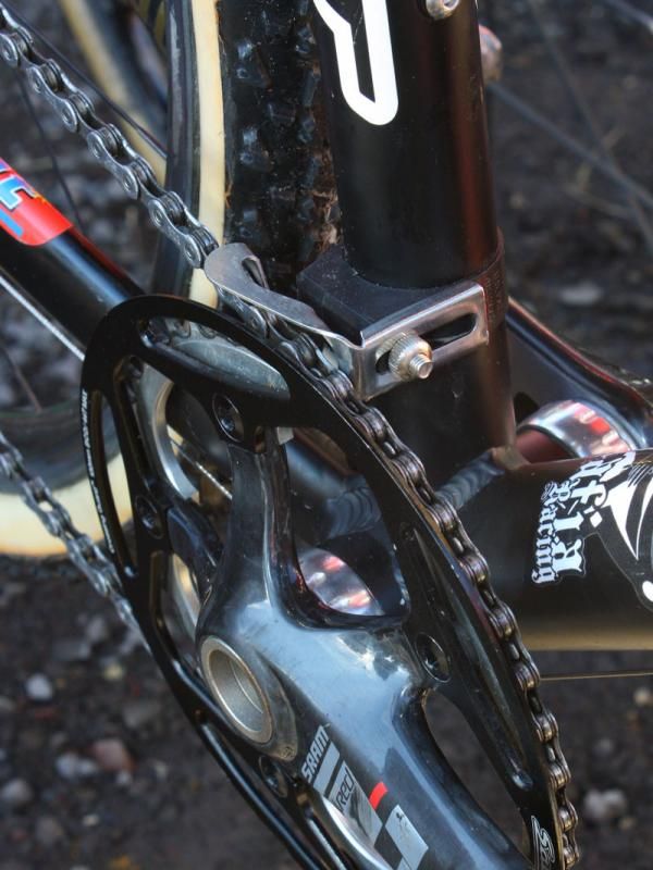 Garmin-Transitions team mechanic Tom Hopper crafted this solution for Mafia Racing 'cross star Jake Wells. The N-Gear Jump Stop is mounted upside-down on the seat tube and the extra tab of metal - which now sits up high instead of down low - is bent in a vise to keep the chain from jumping off the top of the ring. In combination with the Salsa outer guard, this setup looks very secure and is still fully adjustable.