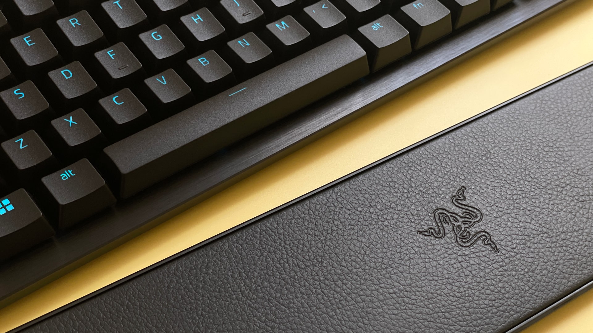 The Razer Huntsman V3 Pro Tenkeyless mechanical gaming keyboard against a yellow background.