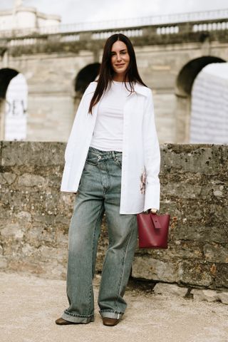 woman wearing fitted white t-shirt, button-down shirt, jeans and flats