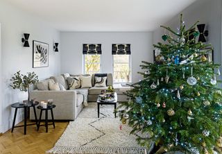 living room with white sofas and christmas tree and black geometric blinds
