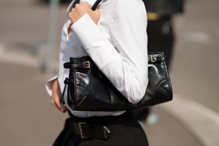 Woman carries Prada bag