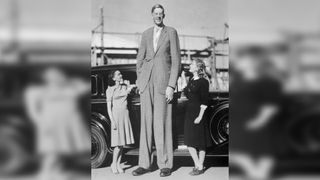 A photo of Robert Wadlow, who as twice as tall as the two actresses standing next to him