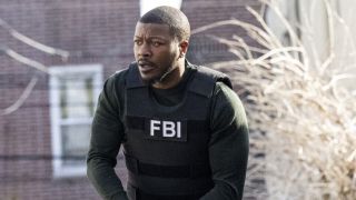 Edwin Hodge as FBI: Most Wanted's Ray Cannon with gun drawn in Season 5x11