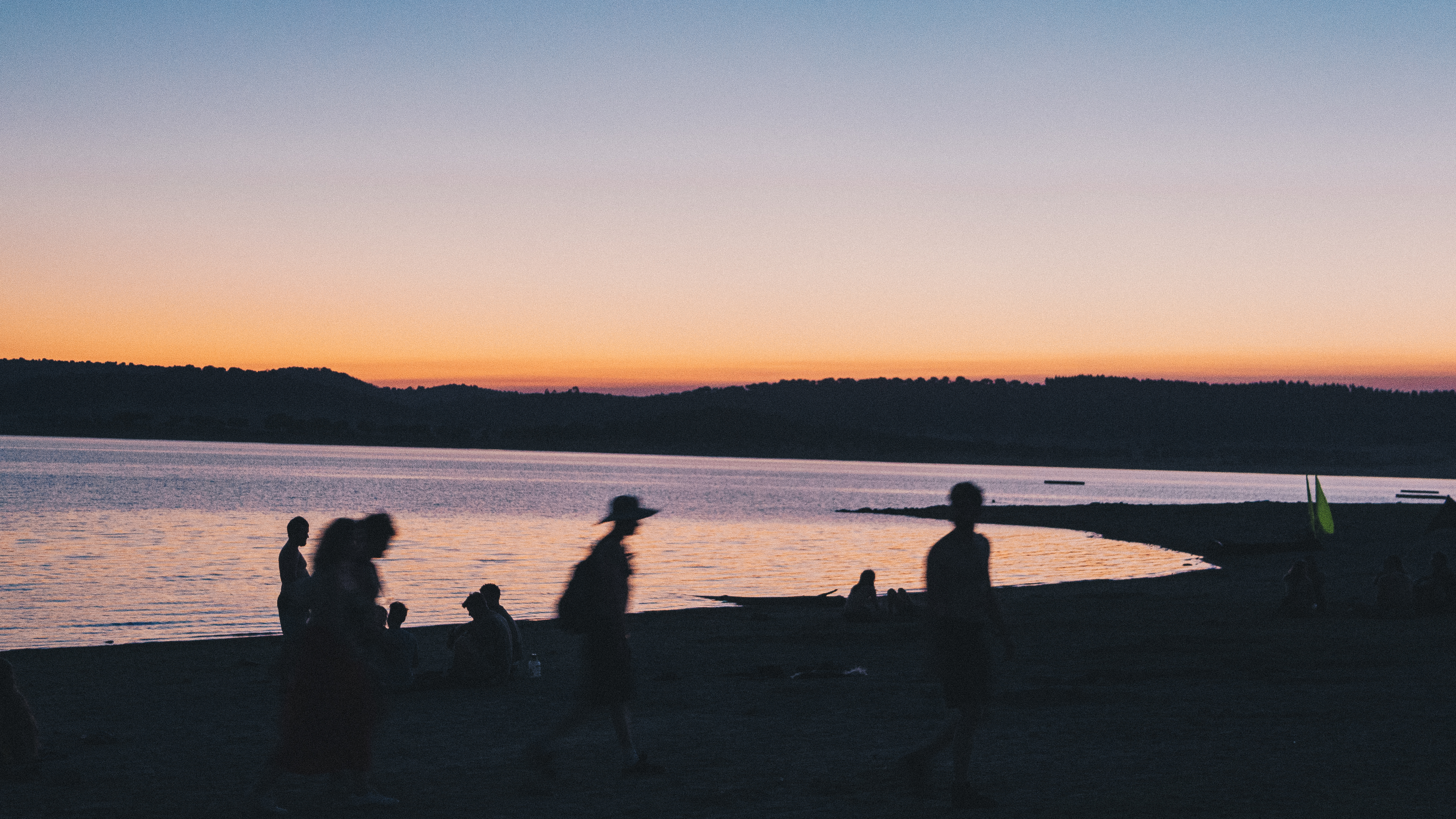 An image of a lake at sunset with silhouetted people in the forground, Olympus EM-5 Mark II sample images
