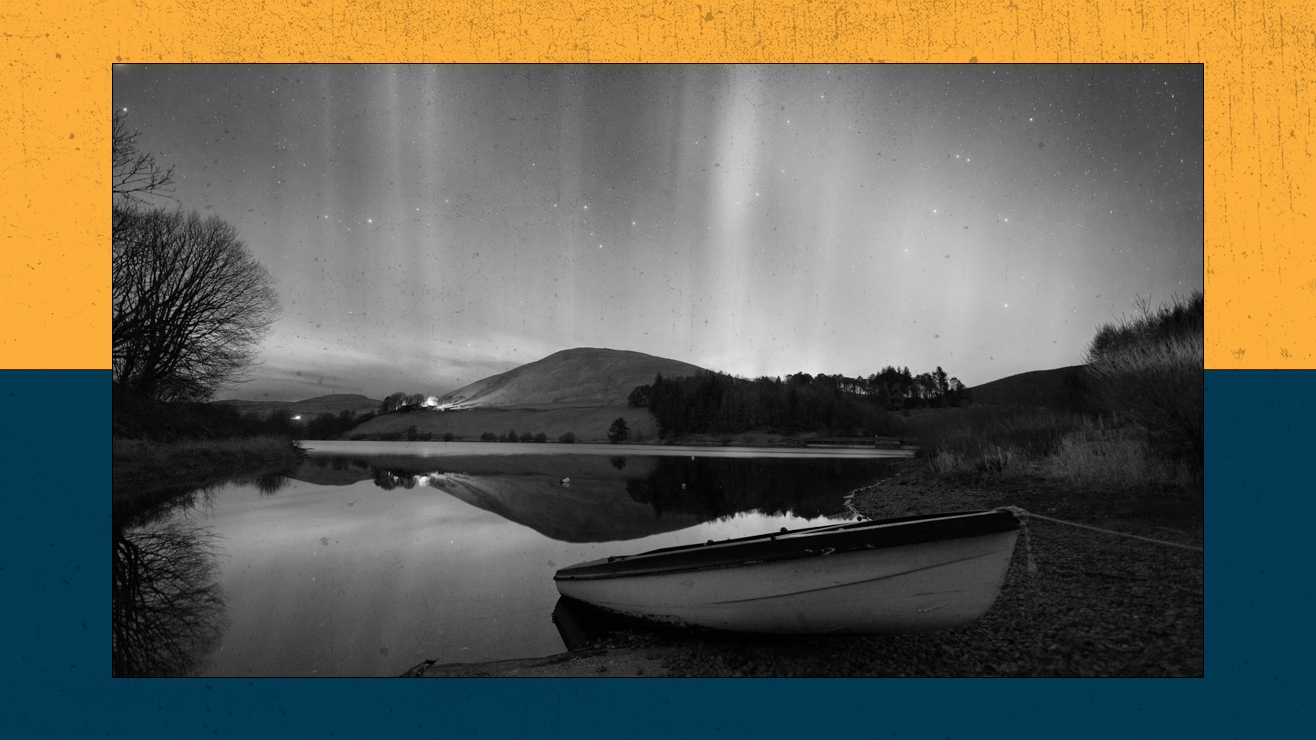 Northern lights shimmer above a nightime sky.