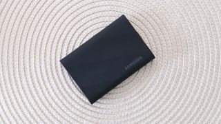 Samsung T9 portable SSD on a white wicker mat