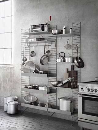 Grey concrete kitchen with metal shelving system