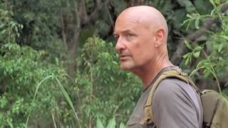 Terry O'Quinn in Lost, walking through the jungle with a backpack on