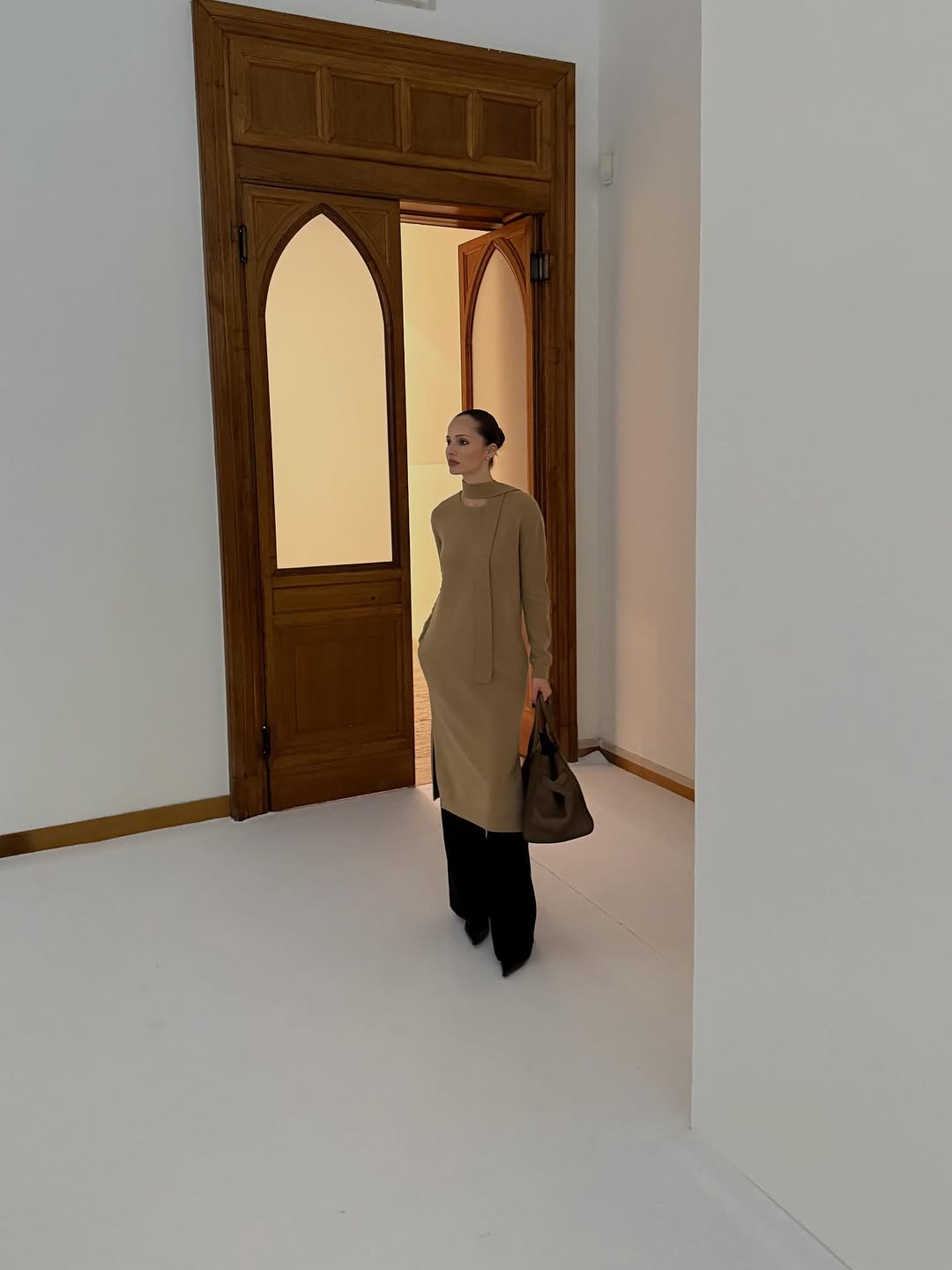 woman wearing dress over pants fall outfit 2025