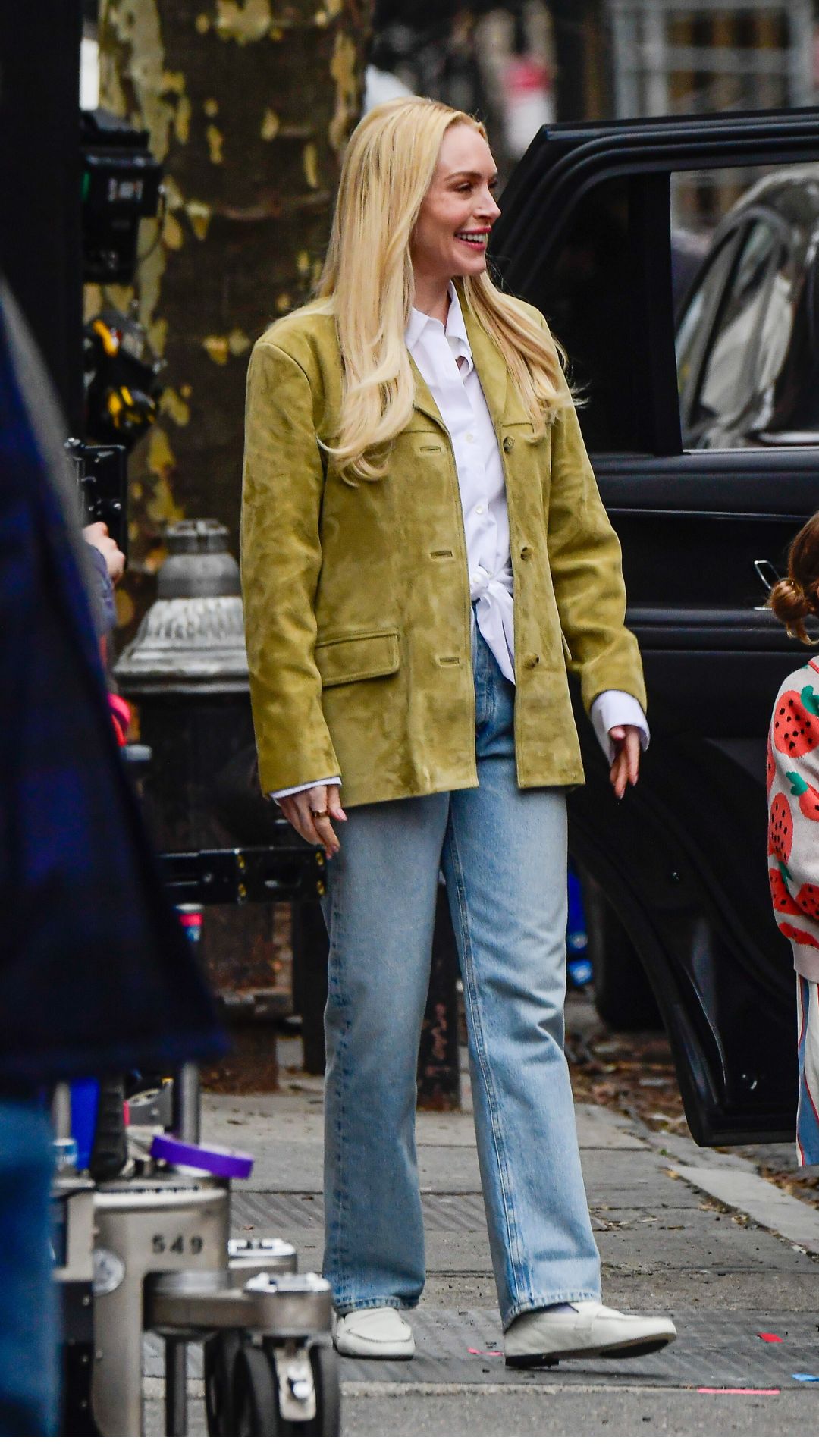 lindsay lohan wearing a suede blazer and jean outfit while filming scenes