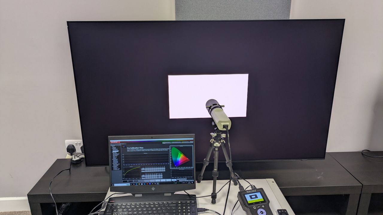 Samsung S95F with testing equipment connected and displaying white window test pattern