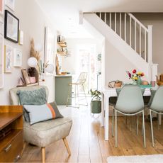 open plan dining area with dining table and green chairs