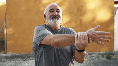 Senior man stretching before exercise