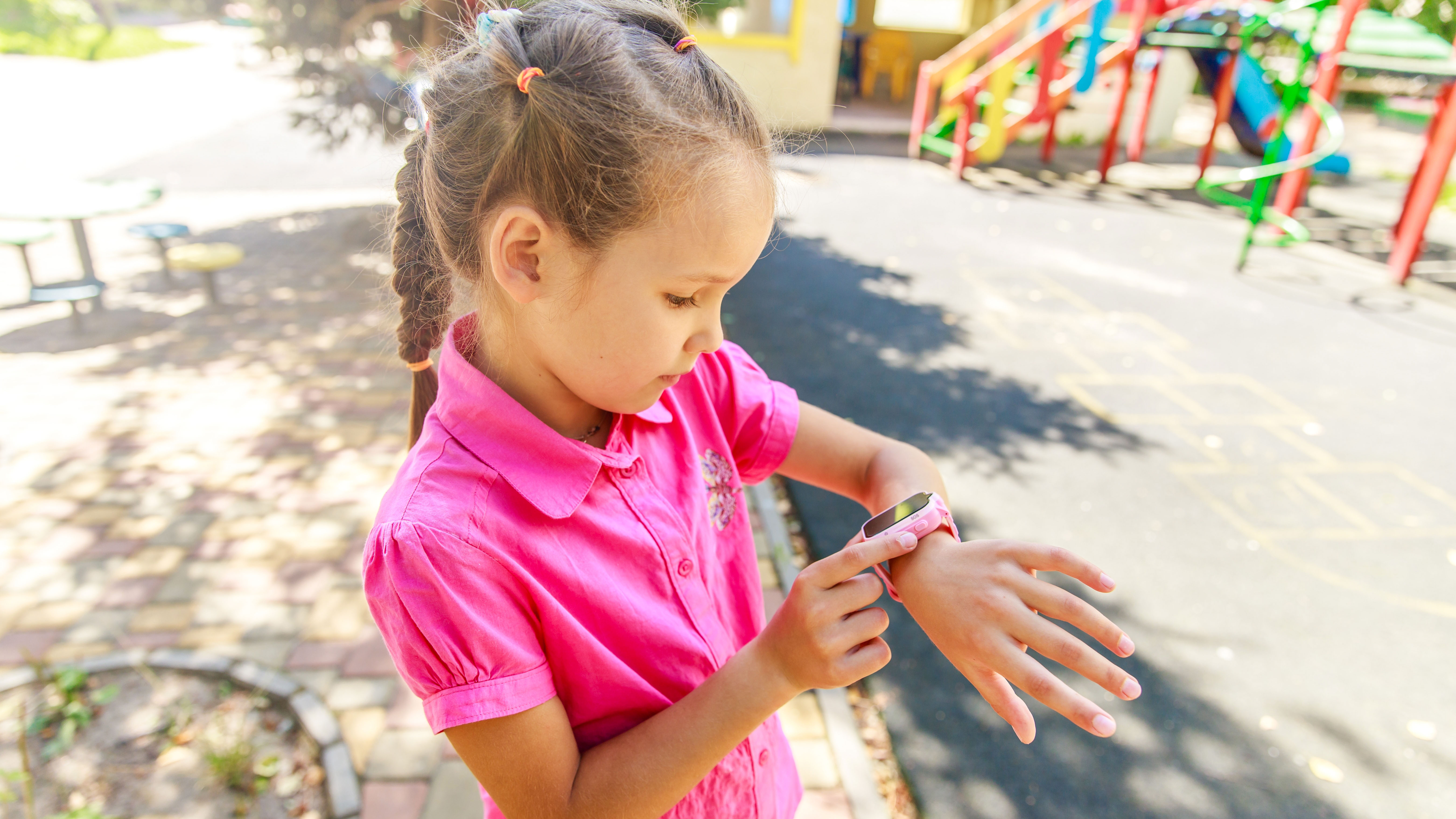 Girl looking at smartwatch on her wrist