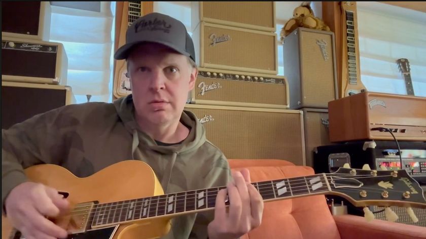 A still of Joe Bonamassa demoing his Gibson ES-350, live from Nerdville. He wears a baseball cap and a hoodie.