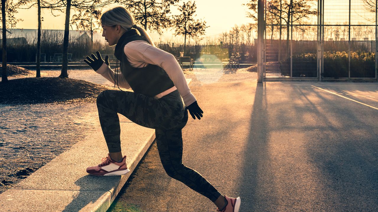 Woman performs a step-up outdoors