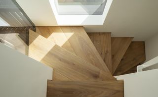 Minimalist wooden staircase and white walls