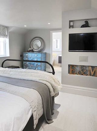 scandinavian style master bedroom suite with recessed shelving