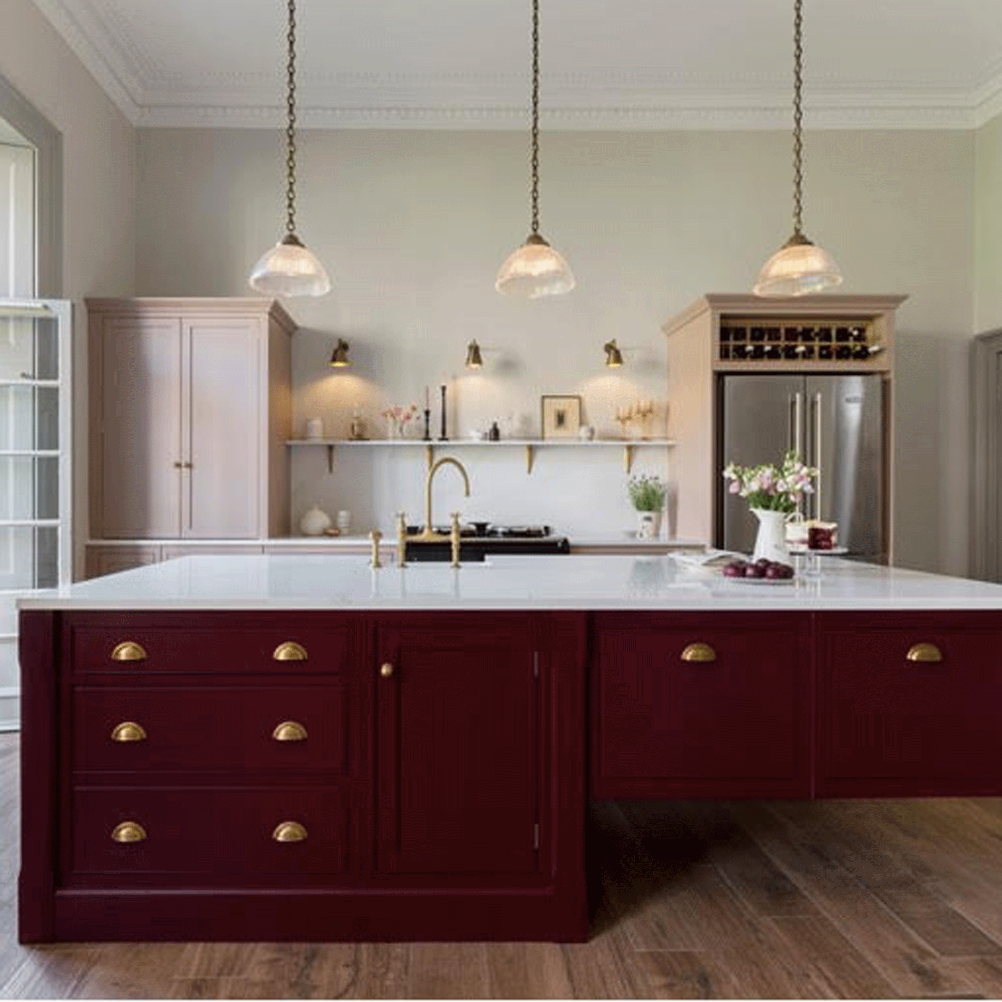 Kitchen with red island and trio of pendant lighting