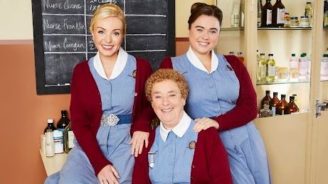 Call the Midwife cast sitting in their uniforms: L-R Trixie Franklin, Phyllis Crane and Nancy Corrigan 