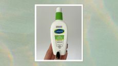 Image of hand holding the Cetaphil Daily Hydrating Moisturiser with black almond nails, on a green watercolour background