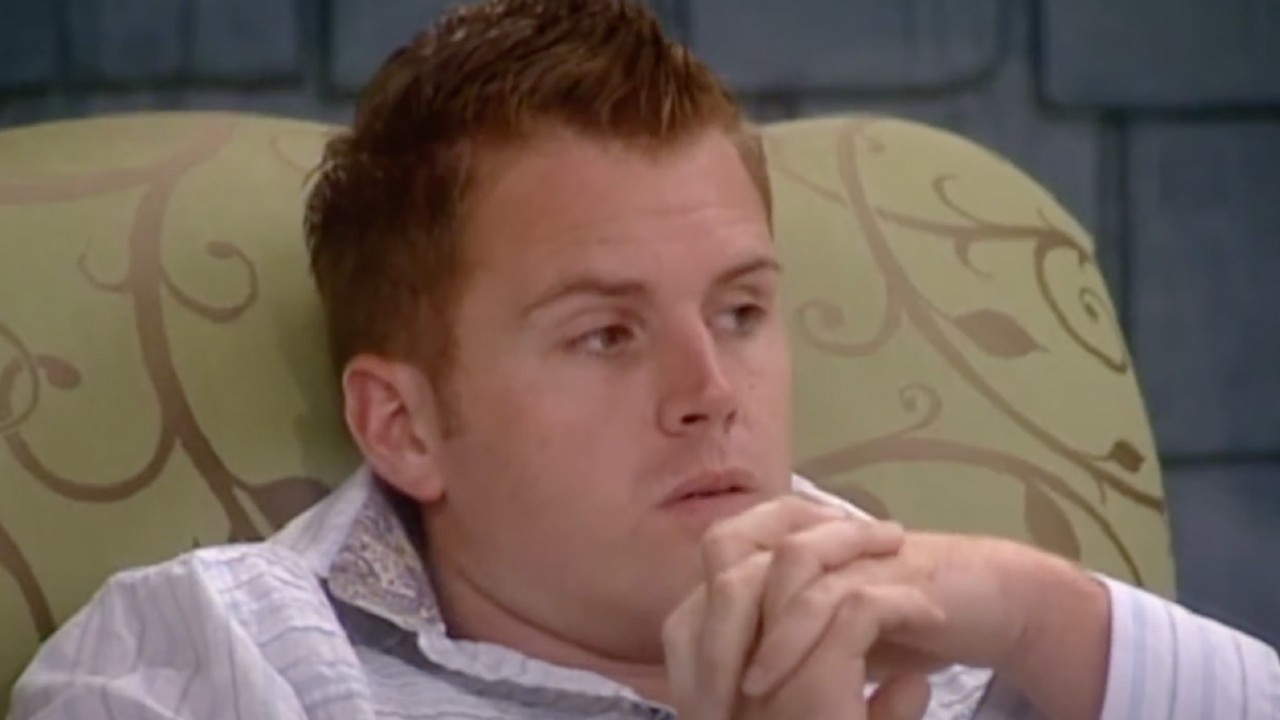 Memphis Garrett listening to a fight on Big Brother