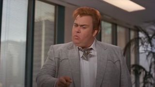 John Candy pointing at something with thought in Who's Harry Crumb.