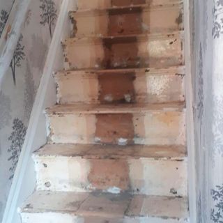 staircase before makeover with white designed wall