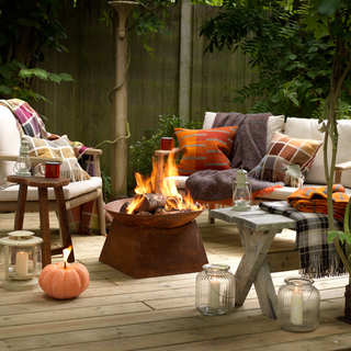 fire pit outdoor sofa with cushions and wooden flooring