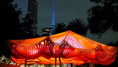 Mpavilion 2022 opens, showing here orange canopy structure at night