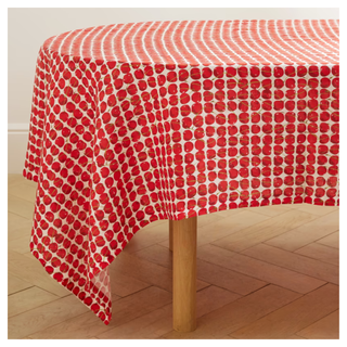 A linen tablecloth from La DoubleJ with a red cherry pattern