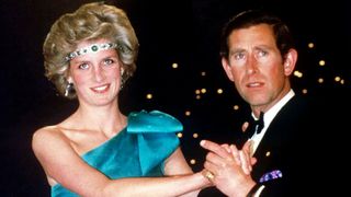MELBOURNE, AUSTRALIA - OCTOBER 01: Prince Charles Dancing With His Wife, Princess Diana, In Melbourne, During Their Official Tour Of Australia. The Princess Is Wearing A Diamond And Emerald Choker (a Wedding Gift From The Queen) As A Headband With A One-shouldered Turquoise Satin Organza Dress Designed By David And Elizabeth Emanuel.