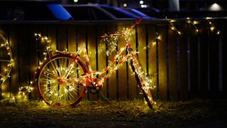 A bicycle illuminated with string lights