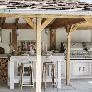 outdoor kitchen with island and dual grill