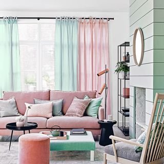 living room with white wall white window with blue pink curtain pink sofa with designed cushions