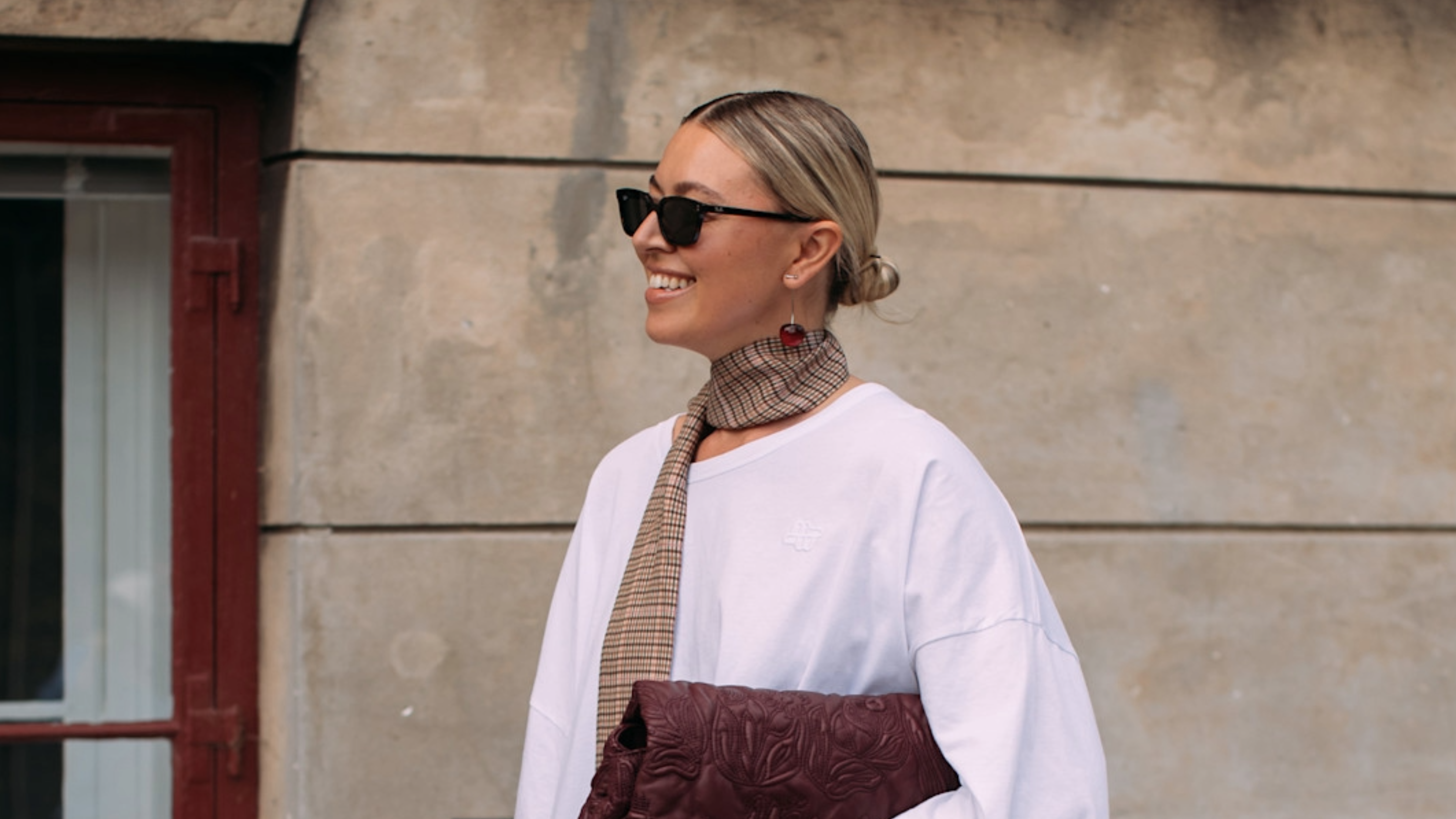 woman wearing a T-shirt and tan scarf 